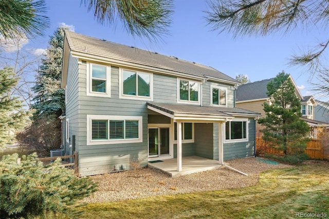 back of house featuring a lawn, a patio area, and central air condition unit