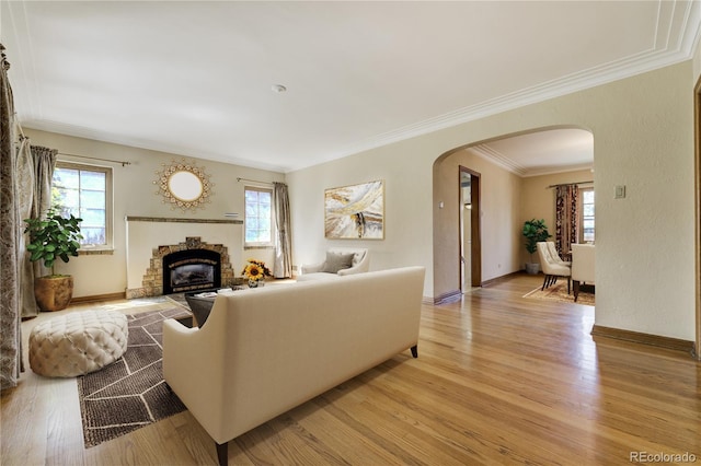 2285 N Monaco Pkwy, Denver, CO 80207 - living area with arched walkways, healthy amount of natural light, light wood-type flooring, and crown molding