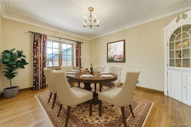 2285 N Monaco Pkwy, Denver, CO 80207 - dining area with a chandelier, ornamental molding, baseboards, and light wood finished floors