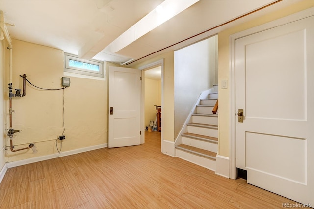 2285 N Monaco Pkwy, Denver, CO 80207 - basement featuring light wood-type flooring, stairs, and baseboards