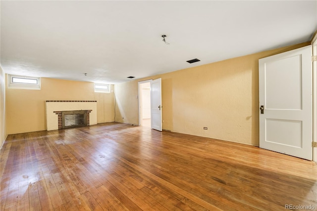 2285 N Monaco Pkwy, Denver, CO 80207 - unfurnished living room featuring a fireplace and wood-type flooring