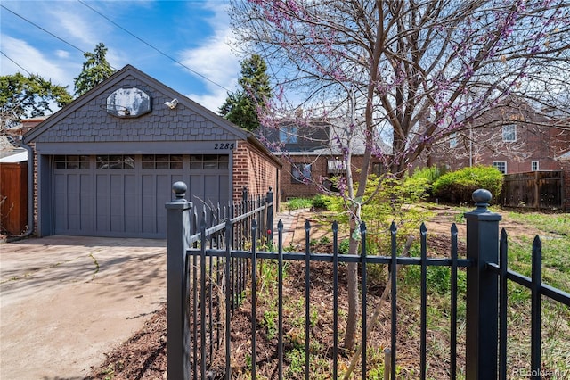 2285 N Monaco Pkwy, Denver, CO 80207 - view of front of house with an outdoor structure, a detached garage, and brick siding