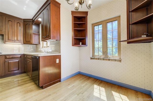 2285 N Monaco Pkwy, Denver, CO 80207 - kitchen with open shelves, light wood-style flooring, light countertops, black dishwasher, and a chandelier