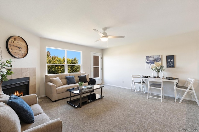 living room with ceiling fan, light colored carpet, and a fireplace