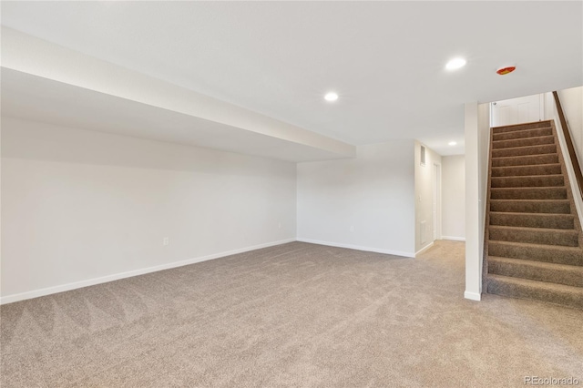 basement featuring light colored carpet