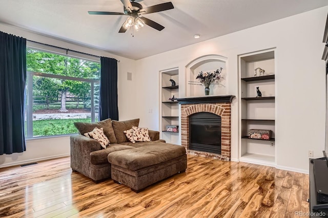 7420 S Houstoun Waring Cir, Littleton, CO 80120 - living area with built in features, wood finished floors, and a fireplace