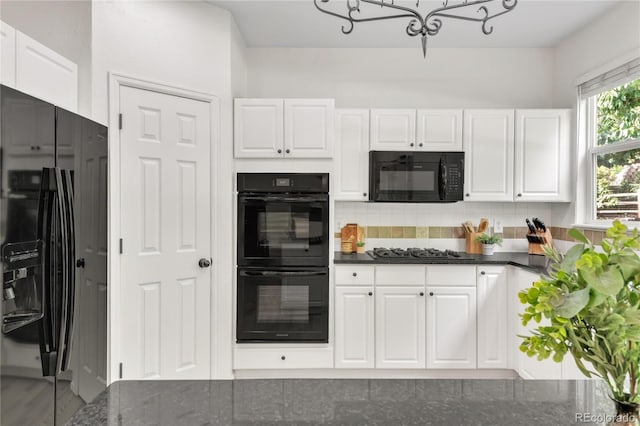7420 S Houstoun Waring Cir, Littleton, CO 80120 - kitchen with black appliances, a chandelier, white cabinets, and backsplash