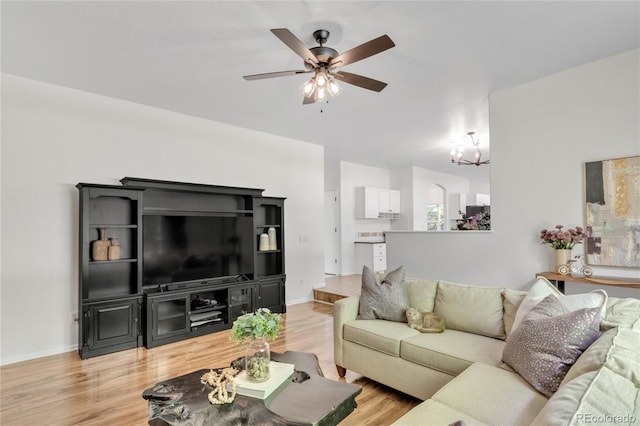 7420 S Houstoun Waring Cir, Littleton, CO 80120 - living room featuring a chandelier, ceiling fan, and light wood-style flooring