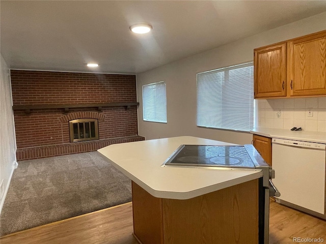 4115 S Vincennes Ct, Denver, CO 80237 - kitchen featuring white dishwasher, a brick fireplace, light countertops, range with electric stovetop, and light wood-type flooring