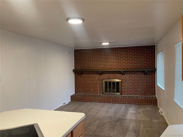 4115 S Vincennes Ct, Denver, CO 80237 - unfurnished living room with carpet flooring, a brick fireplace, and baseboards