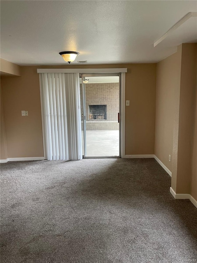 4115 S Vincennes Ct, Denver, CO 80237 - carpeted empty room featuring baseboards, a textured ceiling, and a fireplace