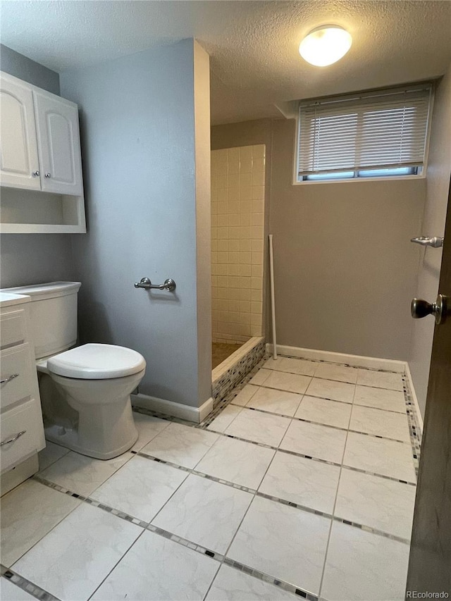 4115 S Vincennes Ct, Denver, CO 80237 - full bath featuring a textured ceiling, toilet, tiled shower, tile patterned flooring, and vanity