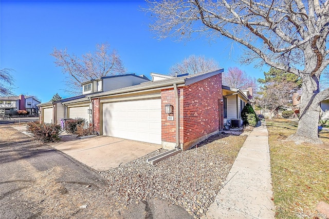 view of side of home featuring a garage and central air condition unit