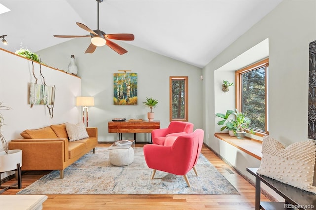 living room with lofted ceiling, light hardwood / wood-style floors, and ceiling fan