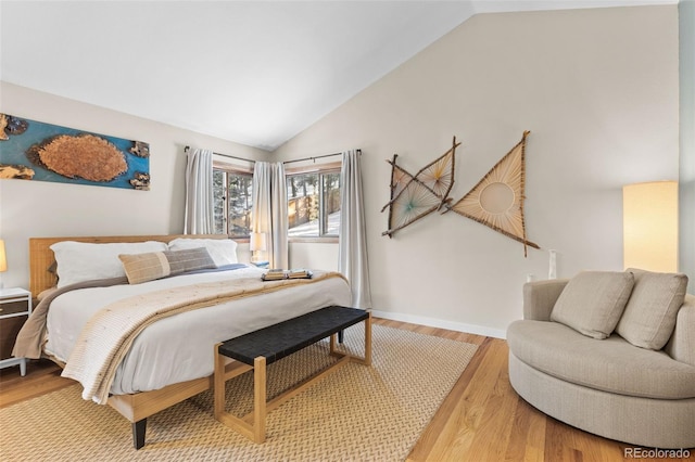 bedroom with lofted ceiling and hardwood / wood-style floors