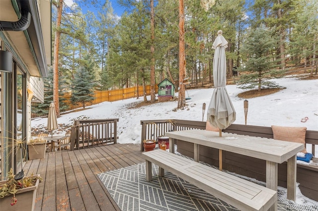 snow covered deck with a playground