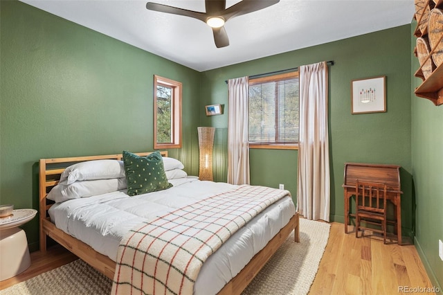 bedroom featuring light hardwood / wood-style flooring and ceiling fan