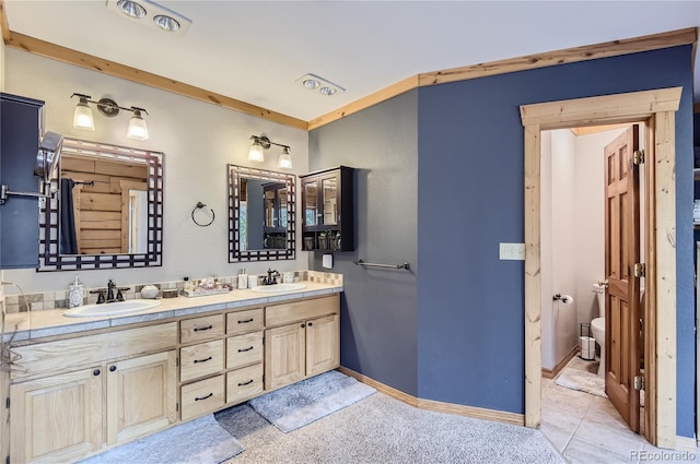 bathroom featuring toilet, vanity, tile patterned floors, and ornamental molding