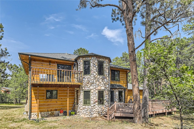 rear view of house featuring a wooden deck