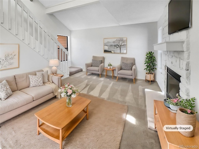 carpeted living room featuring vaulted ceiling with beams and a fireplace