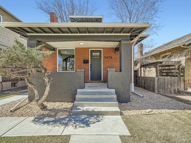 property entrance featuring brick siding