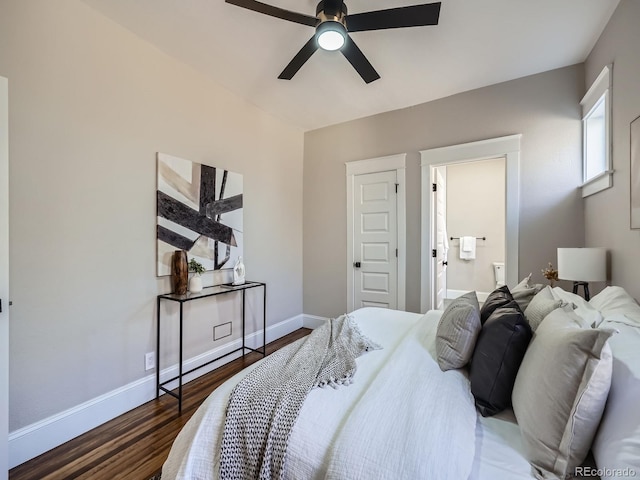 bedroom featuring a ceiling fan, wood finished floors, baseboards, and ensuite bathroom