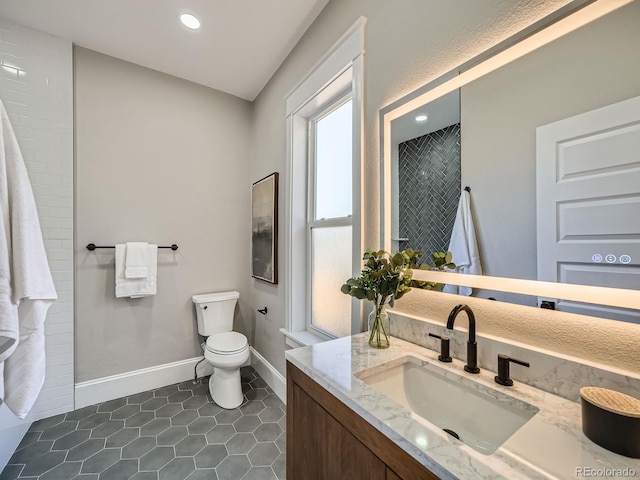 full bath featuring toilet, recessed lighting, tile patterned flooring, baseboards, and vanity