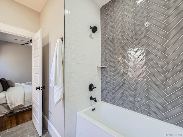 ensuite bathroom featuring ceiling fan, connected bathroom, shower / bath combination, and tile patterned flooring