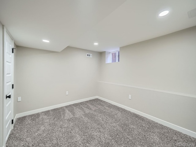 below grade area with visible vents, recessed lighting, baseboards, and carpet