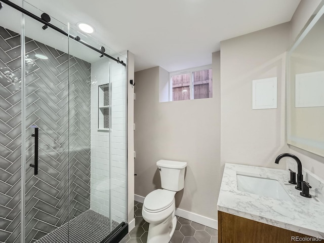 full bathroom featuring tile patterned flooring, baseboards, toilet, a stall shower, and vanity