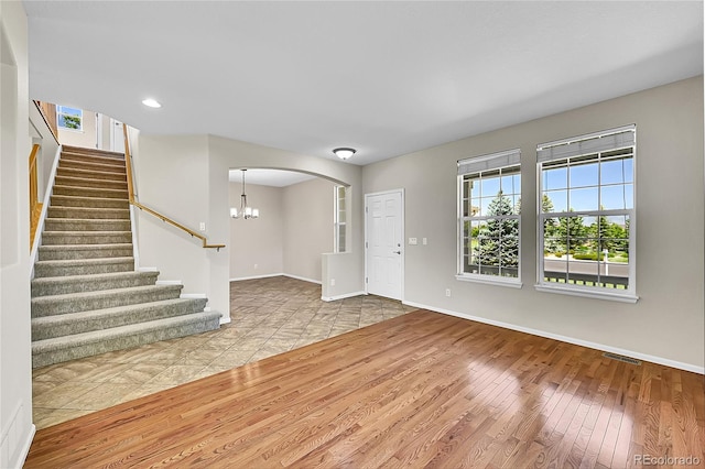 16500 Hitching Post Cir, Parker, CO 80134 - foyer entrance featuring wood finished floors, stairway, arched walkways, a chandelier, and recessed lighting