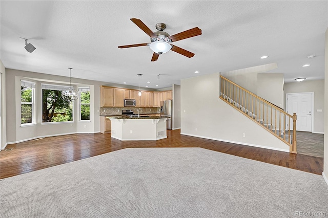 16500 Hitching Post Cir, Parker, CO 80134 - unfurnished living room with stairs, ceiling fan, dark wood-type flooring, recessed lighting, and a textured ceiling