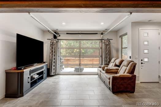 living room featuring beam ceiling