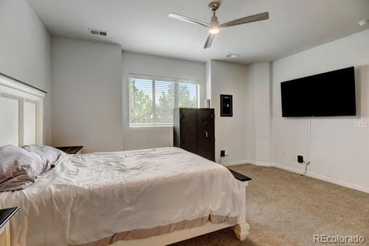 carpeted bedroom with ceiling fan