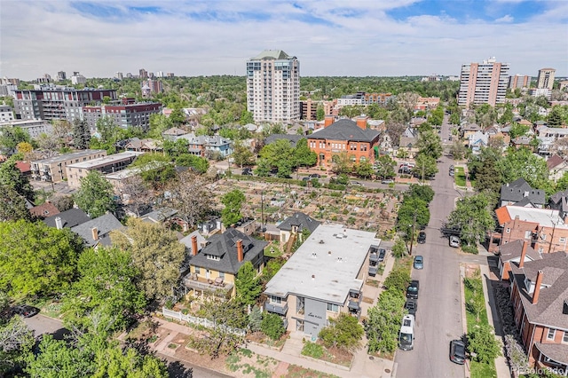 aerial view of property and surrounding area with nearby urban area