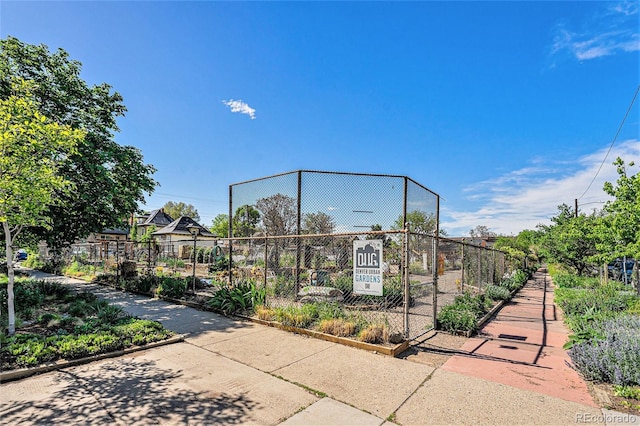 view of home's community featuring fence