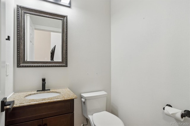 bathroom with toilet and vanity