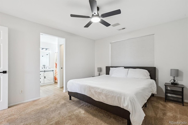 bedroom featuring carpet, visible vents, and a sink