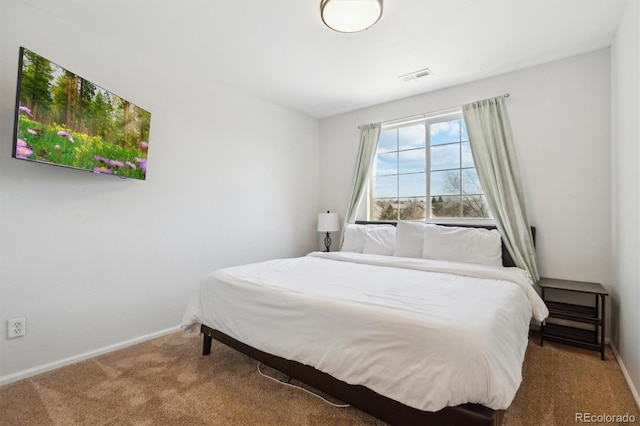 carpeted bedroom with baseboards and visible vents