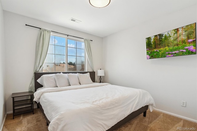 carpeted bedroom with baseboards and visible vents