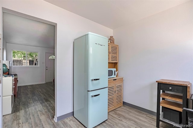 2955 N Gilpin St, Denver, CO 80205 - kitchen featuring white appliances, light wood-type flooring, baseboards, and white cabinets