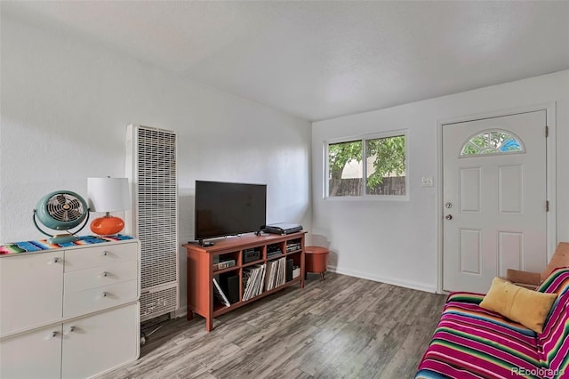2955 N Gilpin St, Denver, CO 80205 - living room featuring a heating unit, light wood-style floors, and baseboards