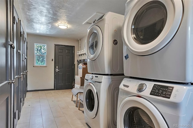 2955 N Gilpin St, Denver, CO 80205 - washroom featuring stacked washing machine and dryer and baseboards