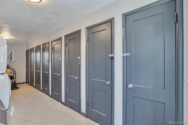 2955 N Gilpin St, Denver, CO 80205 - corridor with washer / clothes dryer, baseboards, and a textured ceiling
