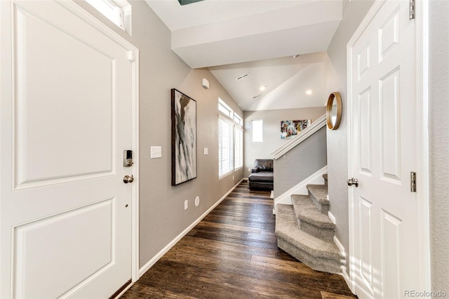 entryway with dark hardwood / wood-style flooring and vaulted ceiling