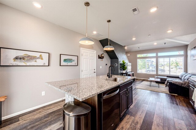 kitchen with a center island with sink, sink, hanging light fixtures, stainless steel dishwasher, and dark hardwood / wood-style floors