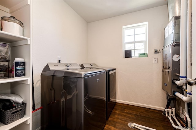 laundry area featuring separate washer and dryer and dark hardwood / wood-style flooring