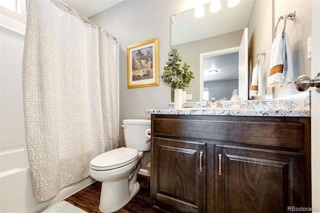 full bathroom featuring wood-type flooring, vanity, toilet, and shower / bath combination with curtain