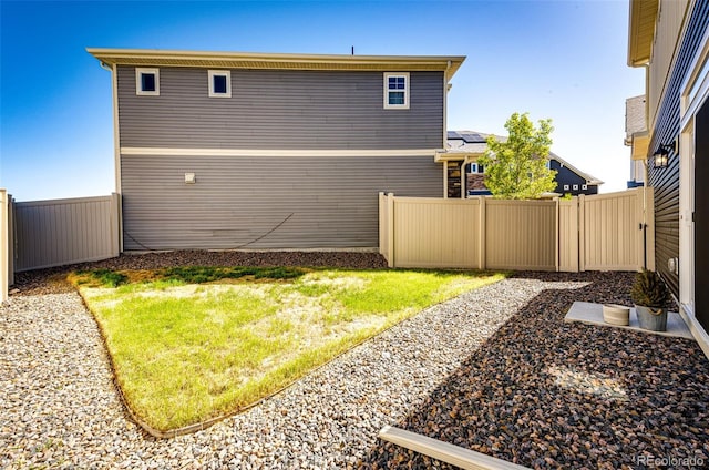 view of side of property with a lawn