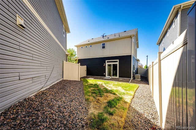 rear view of property featuring central AC unit